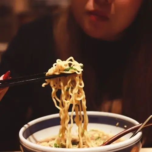 A women eating ramen