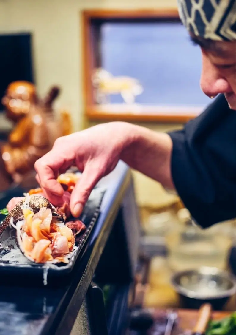 Man putting food on a plate