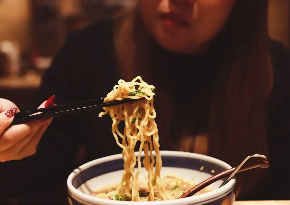 A woman eating ramen